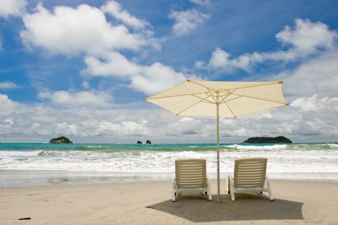 Beach umbrella and chairs on Playa Espadilla in Manuel Antonio
