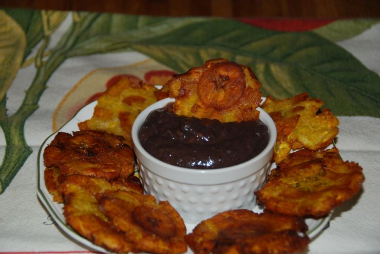 Amazing fried Patacones served with black beans