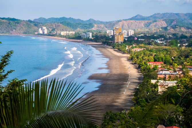 Tropical wide sandy beach of the town of Jacó