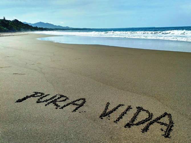 Pura Vida written in the sand at Playa Negra in Puerto Viejo