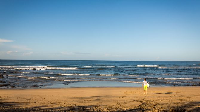 Surfers walking out to the surf at Playa Negra near Tamarindo