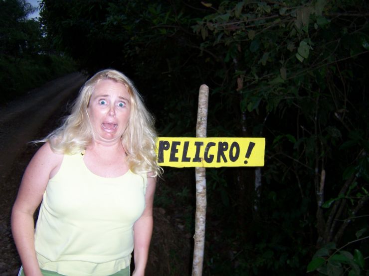 Scared Tourist next to a Danger sign