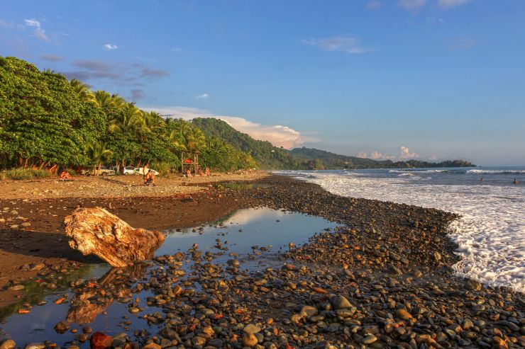 Surfers walking out to the beach at Dominical