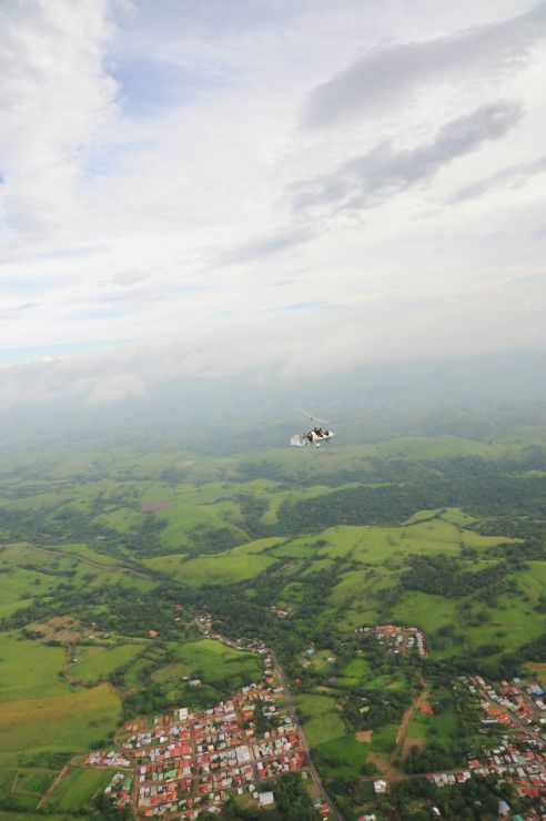 Amazing view of Gyroplane over little town near Manuel Antonio