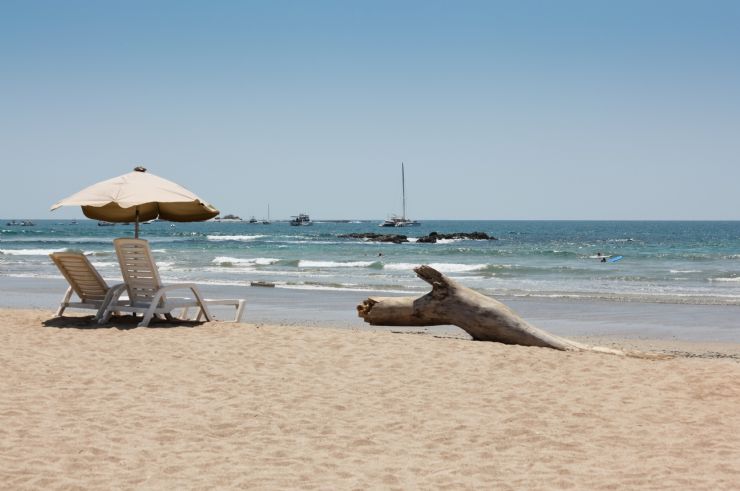 Chairs & umbrella on a empty beach in Tamarindo