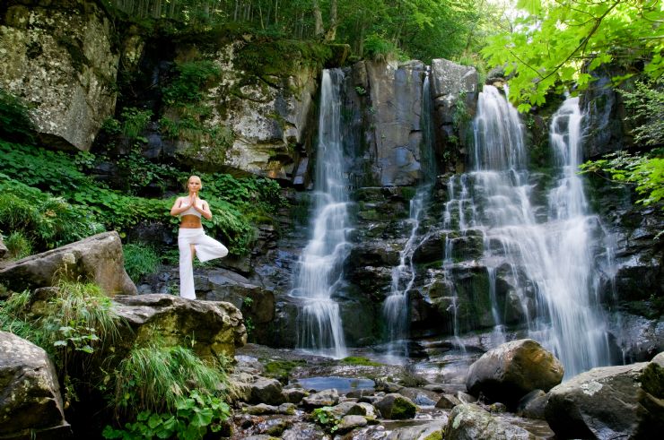 Yoga girl next to a wonderful waterfall in Montezuma
