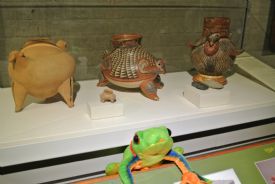 Javi the Frog next to old pottery made by indigenous