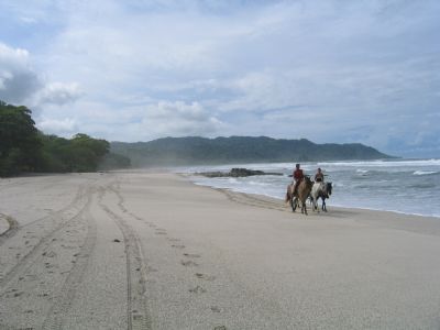 Tourists on the main strip of Santa Teresa on south coast of the