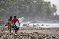 Surfers walking at Pavones