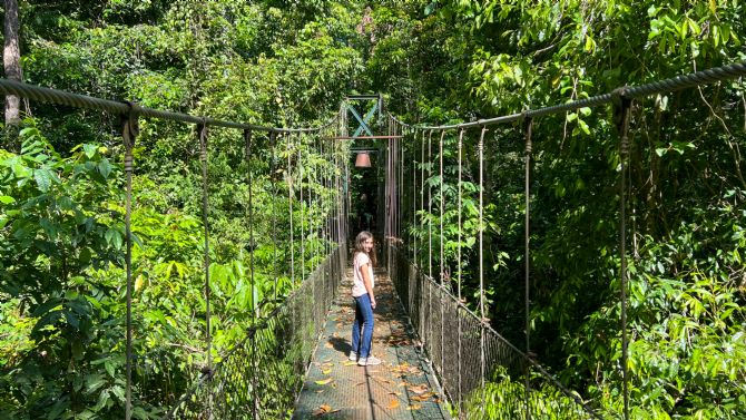 Crossing the hanging bridge at Bosque del Cabo Rainforest Lodge