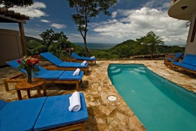 Relaxing chairs by the pool at Recreo