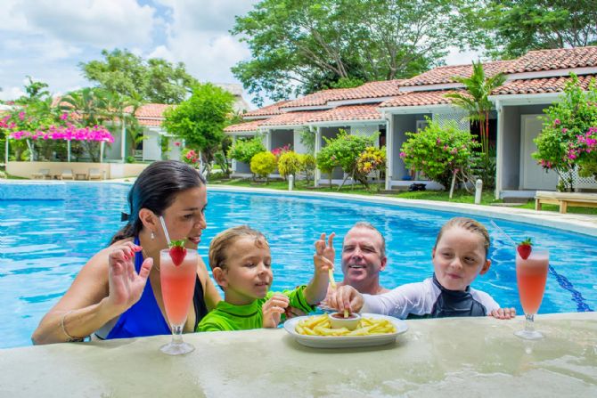 Family enjoying the pool and food