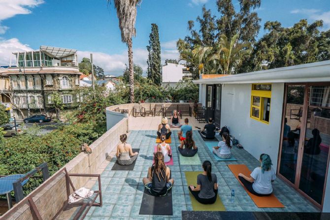 Doing yoga on the rooftop deck at Selina San José