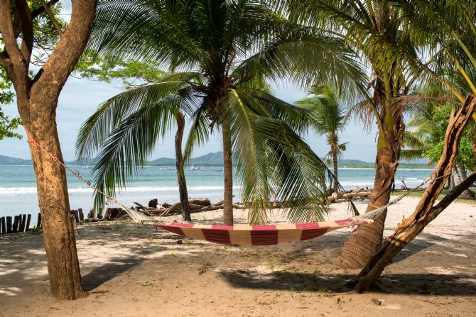 Hammock on the beach in front of The Coast Beachfront Hotel