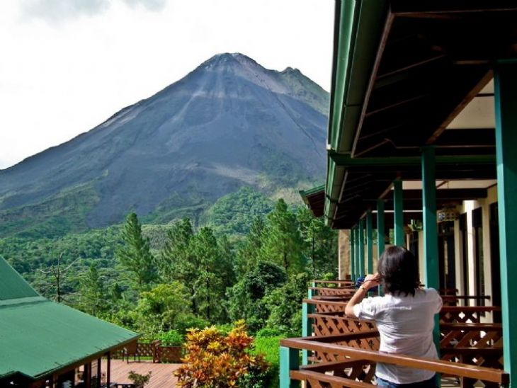 Admiring Arenal Volcano from standard room terrace at Arenal Observatory Lodge